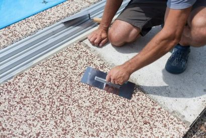 An expert concreter installing exposed aggregate concrete for a pool sidewalk in Perth WA.