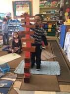 Kid playing Brown Stair  — Preschool & Daycare in Virginia Beach, VA