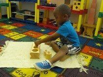 Kid playing Knobless Cylinders  — Preschool & Daycare in Virginia Beach, VA
