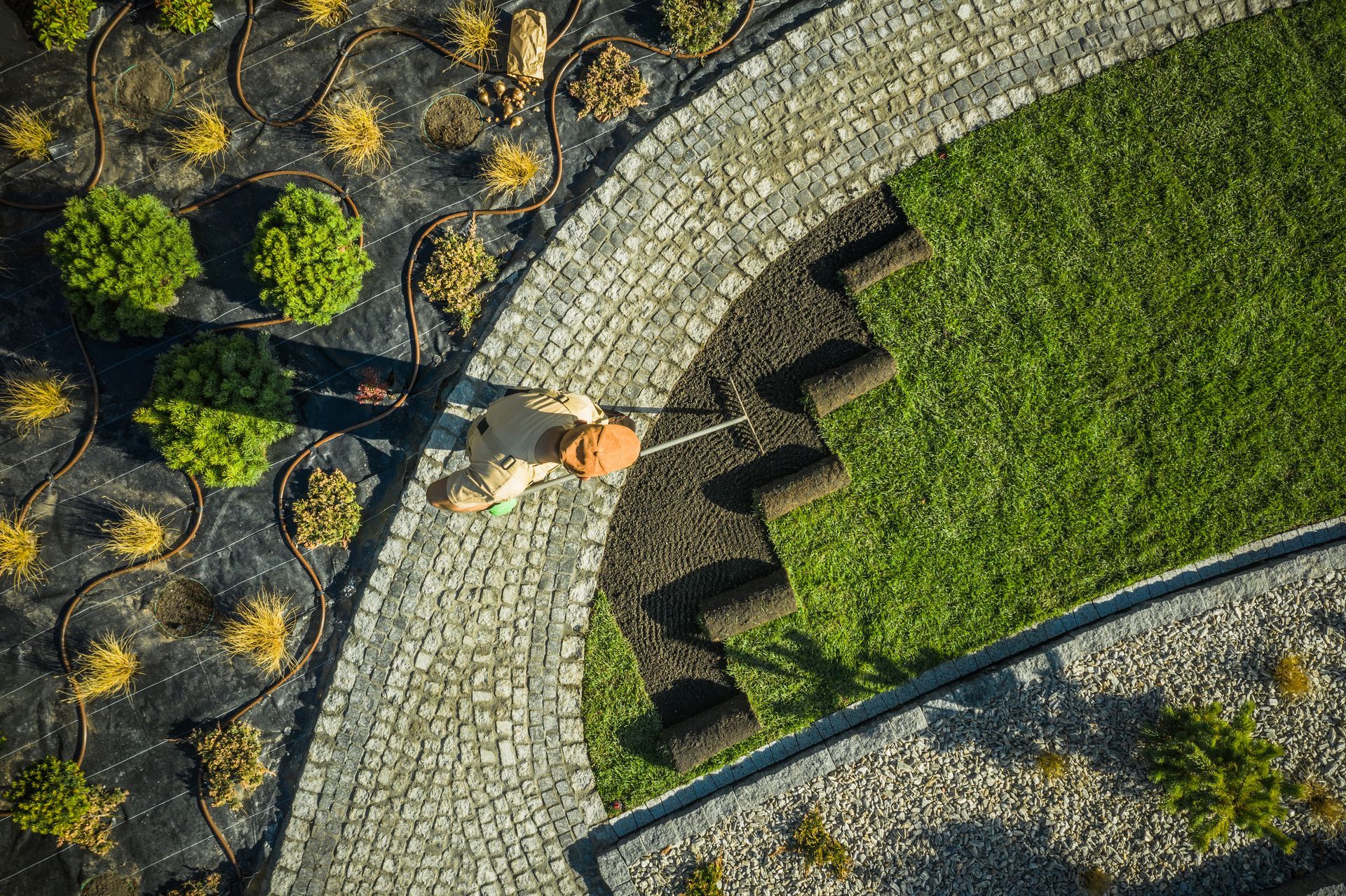 An aerial view of a person walking a dog on a leash.