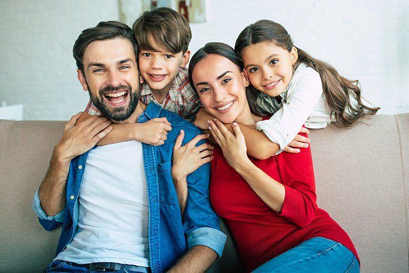 Family Relax Together at Home Smiling and Hugging — Phoenix, AZ — National Health & Wealth Advisors