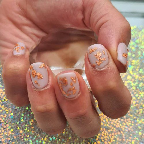 white nails with gold pattern