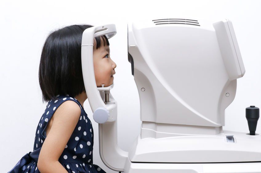young girl getting vision screening