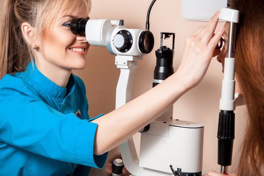 photo of a female optometrist examining a patient's eyes