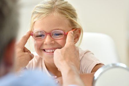 young girl being fitted for glasses