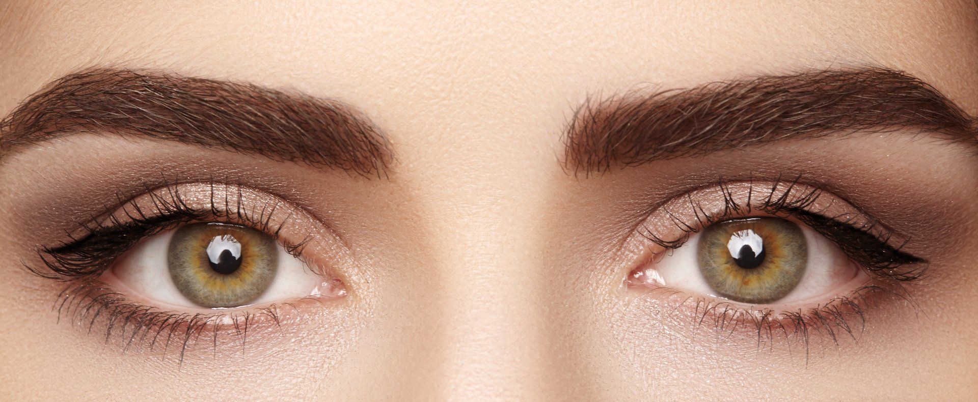 close up of a person's eyes and eyebrows with makeup