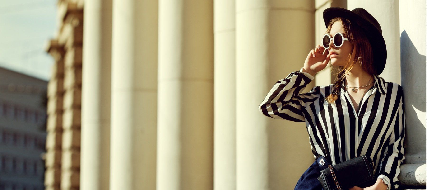 woman in hat wearing sunglasses