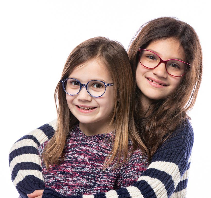 Two young girls wearing prescription glasses