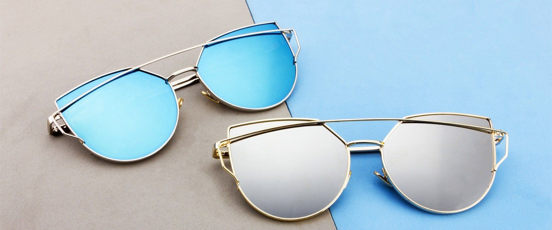 Two pair of sunglasses.One with blue lenses, one with gray lenses