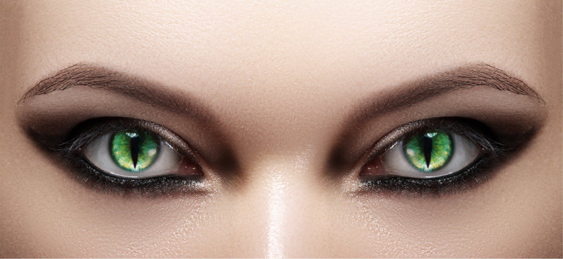 Woman wearing green cat eye theatrical contact lenses