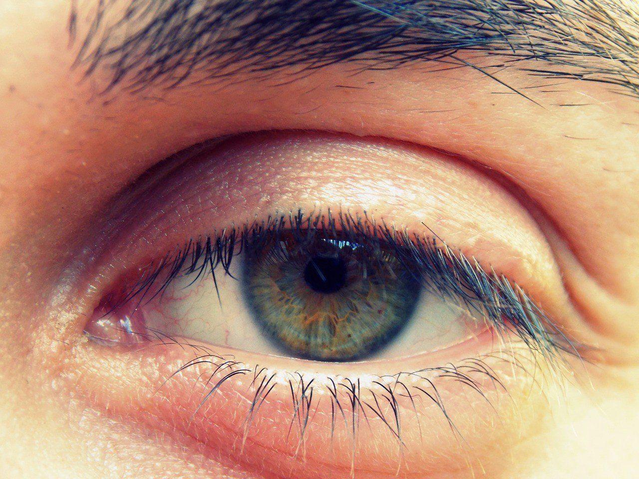 A close up of a person 's green eye