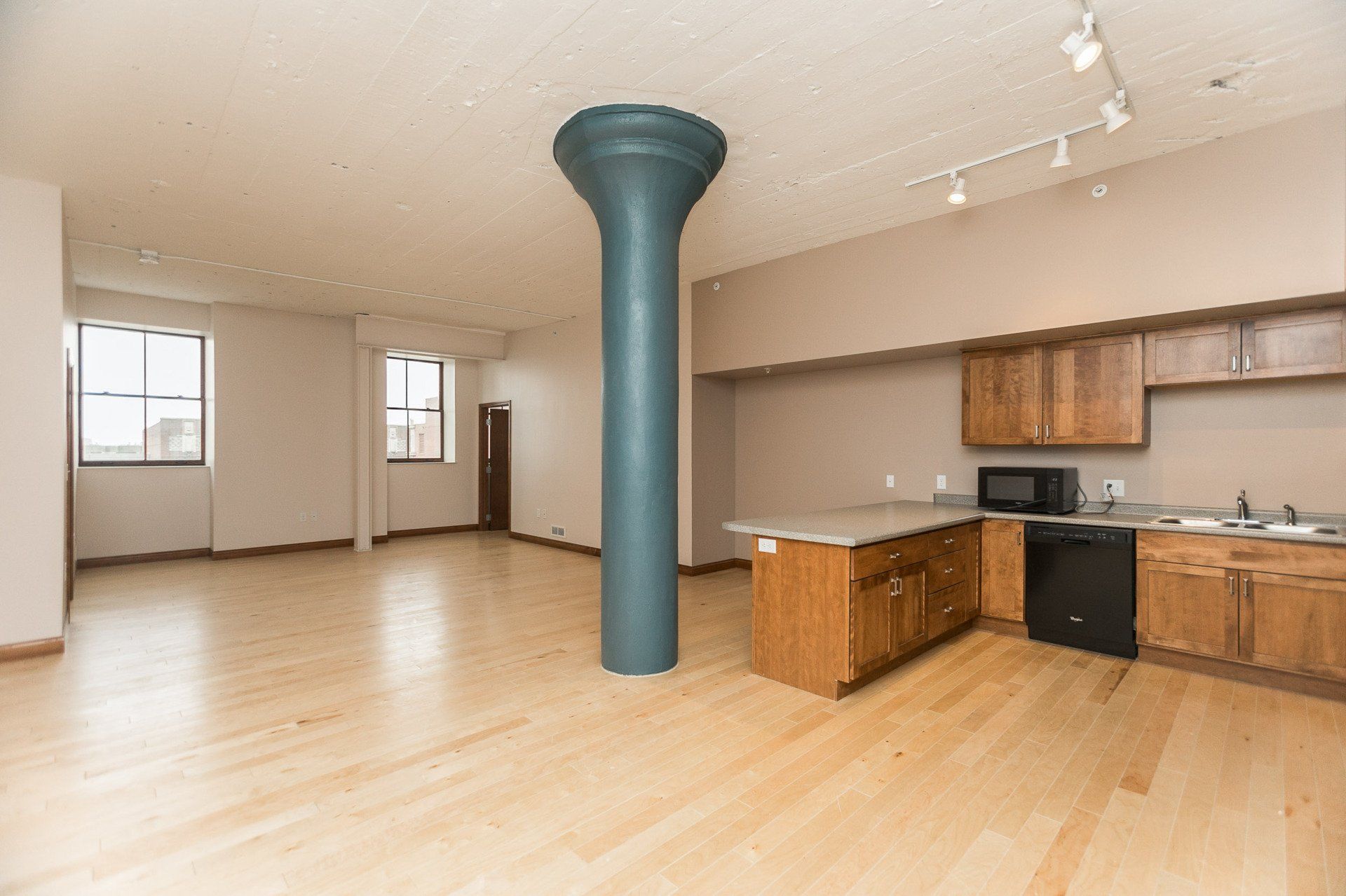 Interior view of kitchen and living room with hardwood floors
