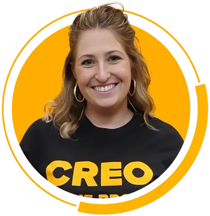 A woman wearing a black shirt with the word creo on it