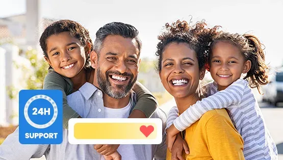A family is posing for a picture together and smiling.