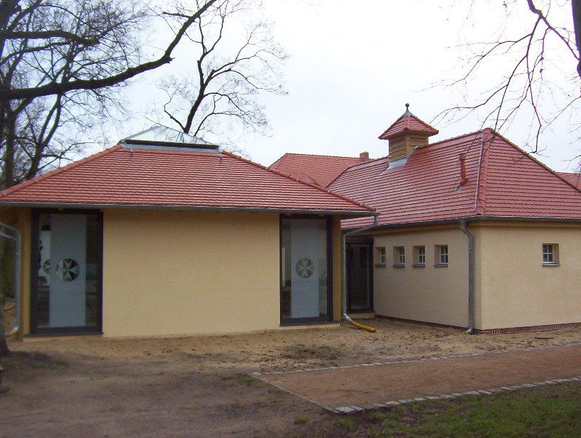 A yellow building with a red tiled roof