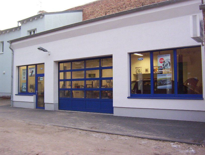 A white building with a blue garage door