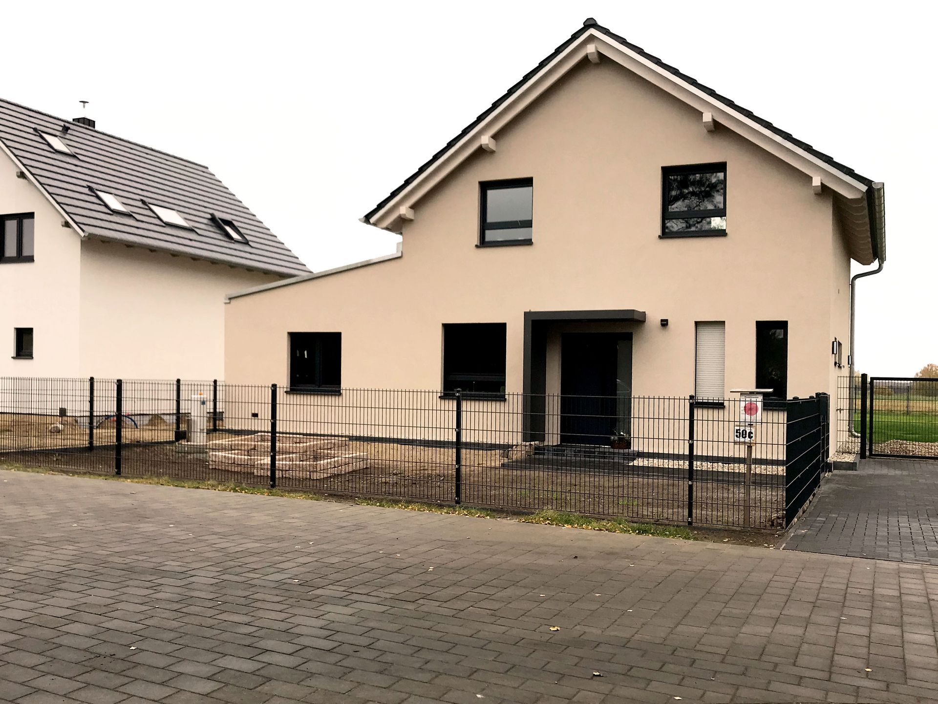 A house with a fence in front of it