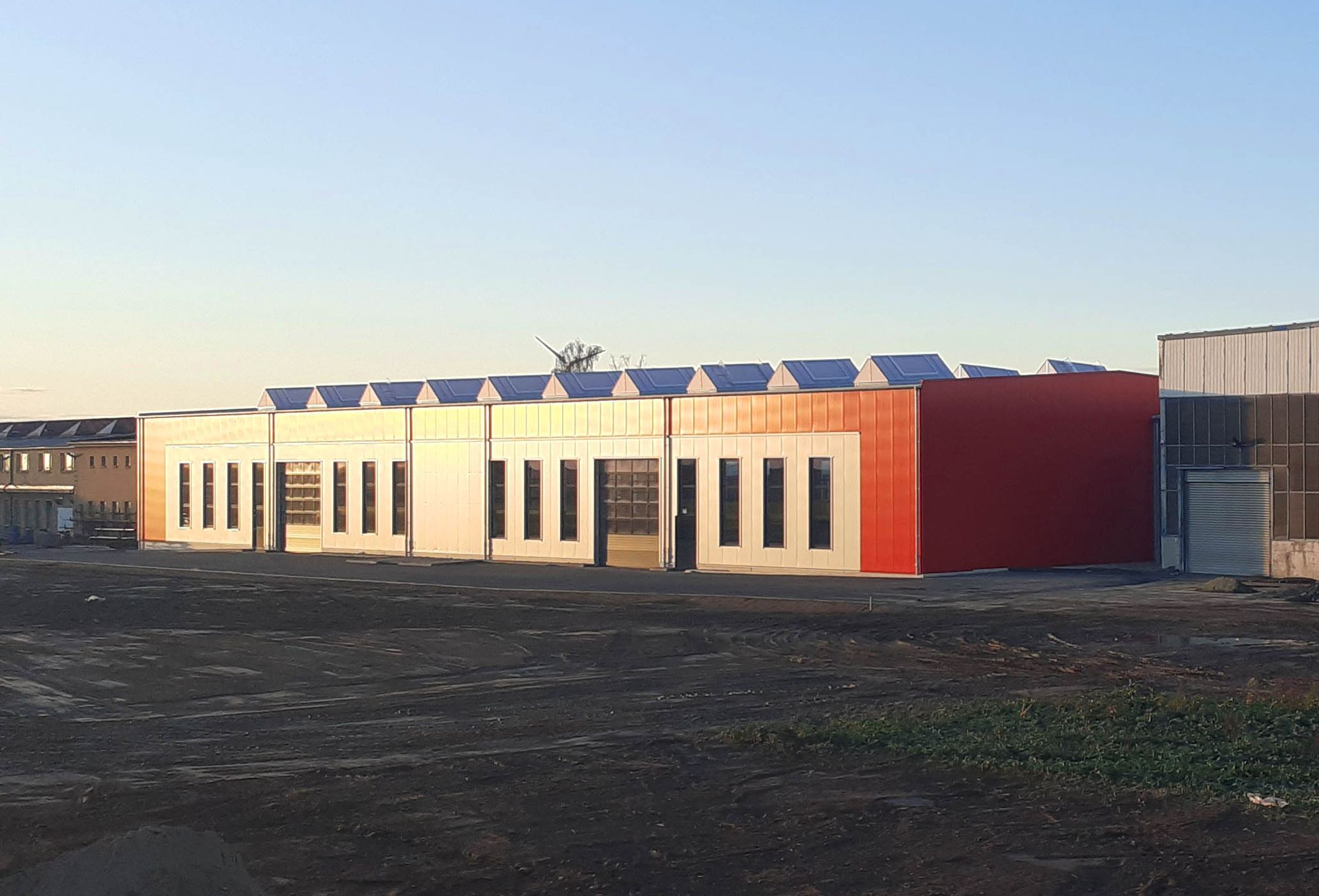 A large red and white building with a blue sky in the background.