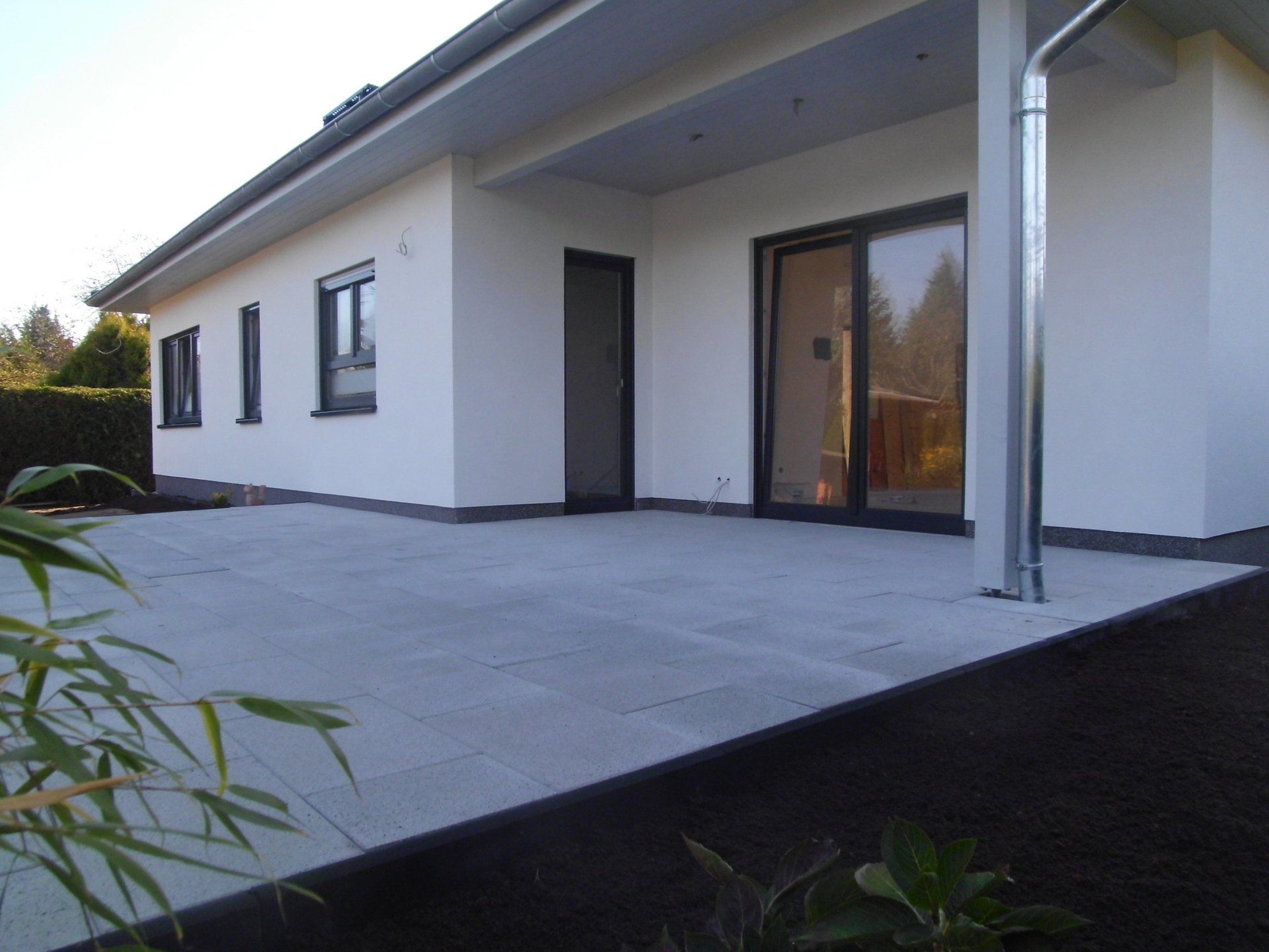 A white house with a patio in front of it