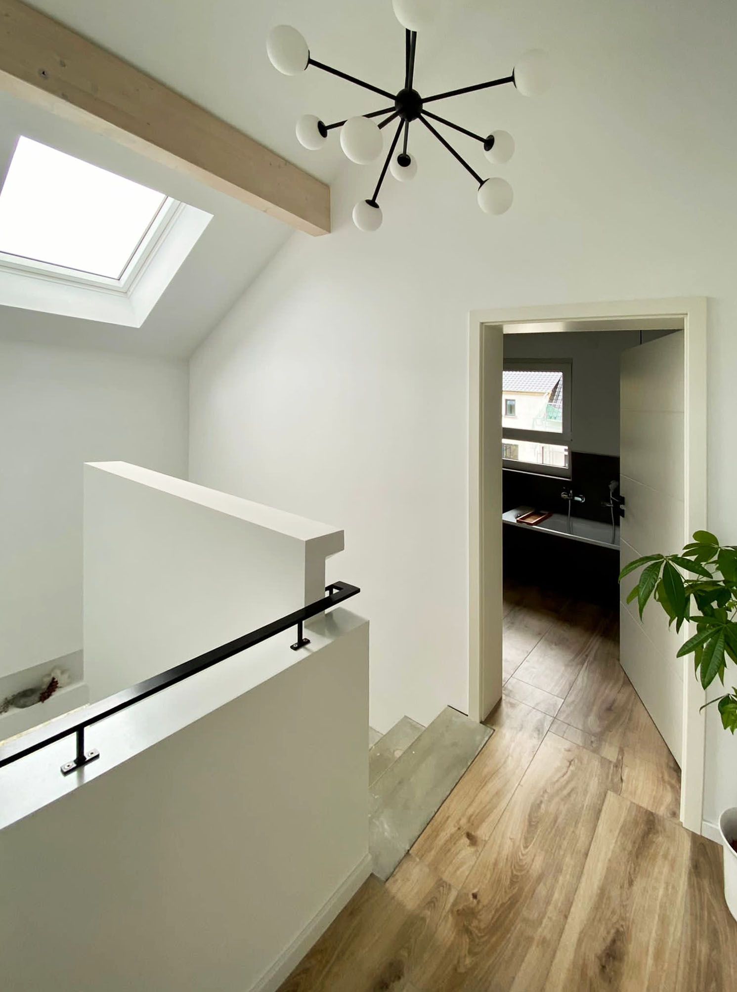 A hallway with stairs leading up to the second floor of a house.