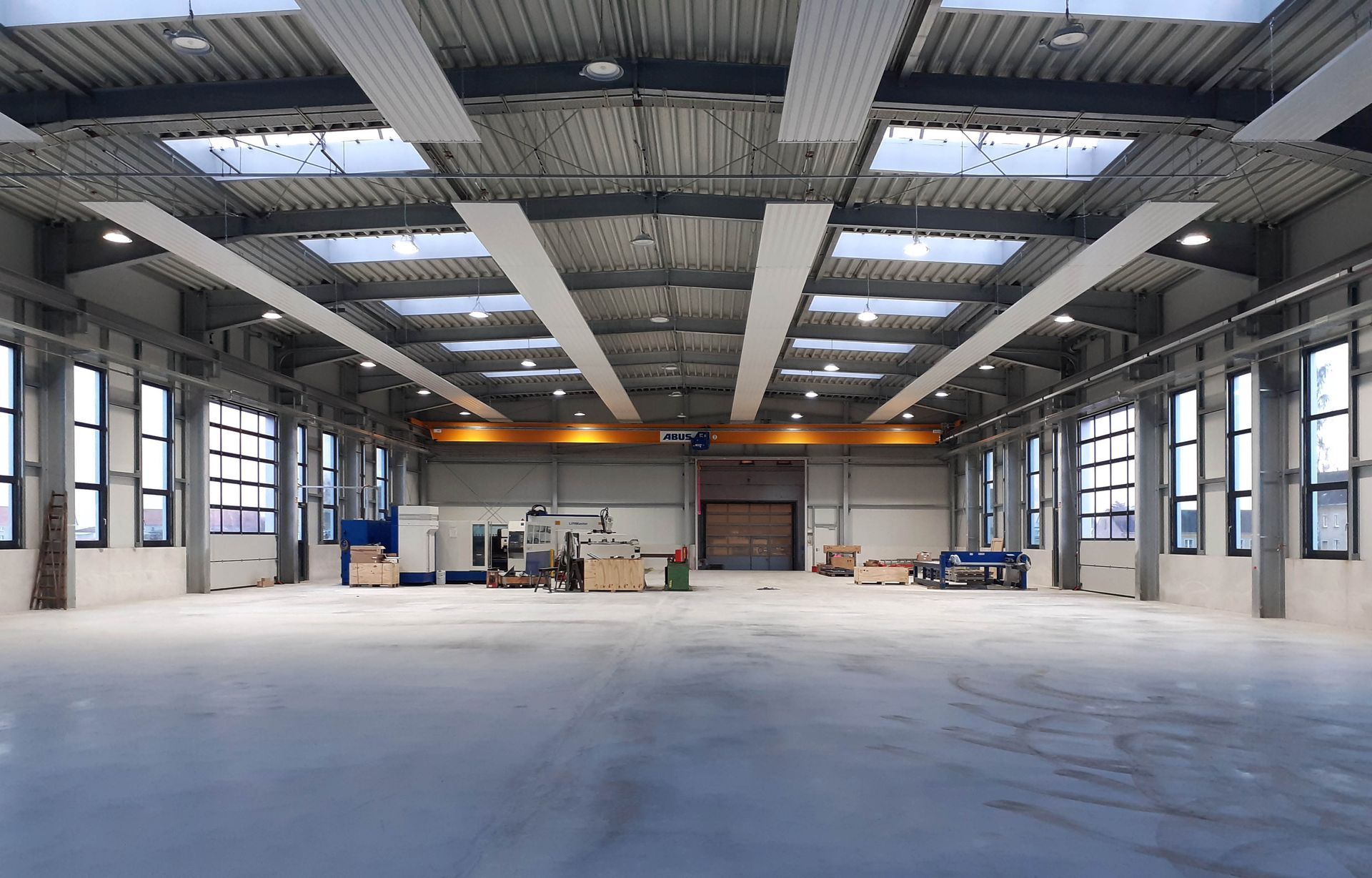 A large empty warehouse with a lot of windows