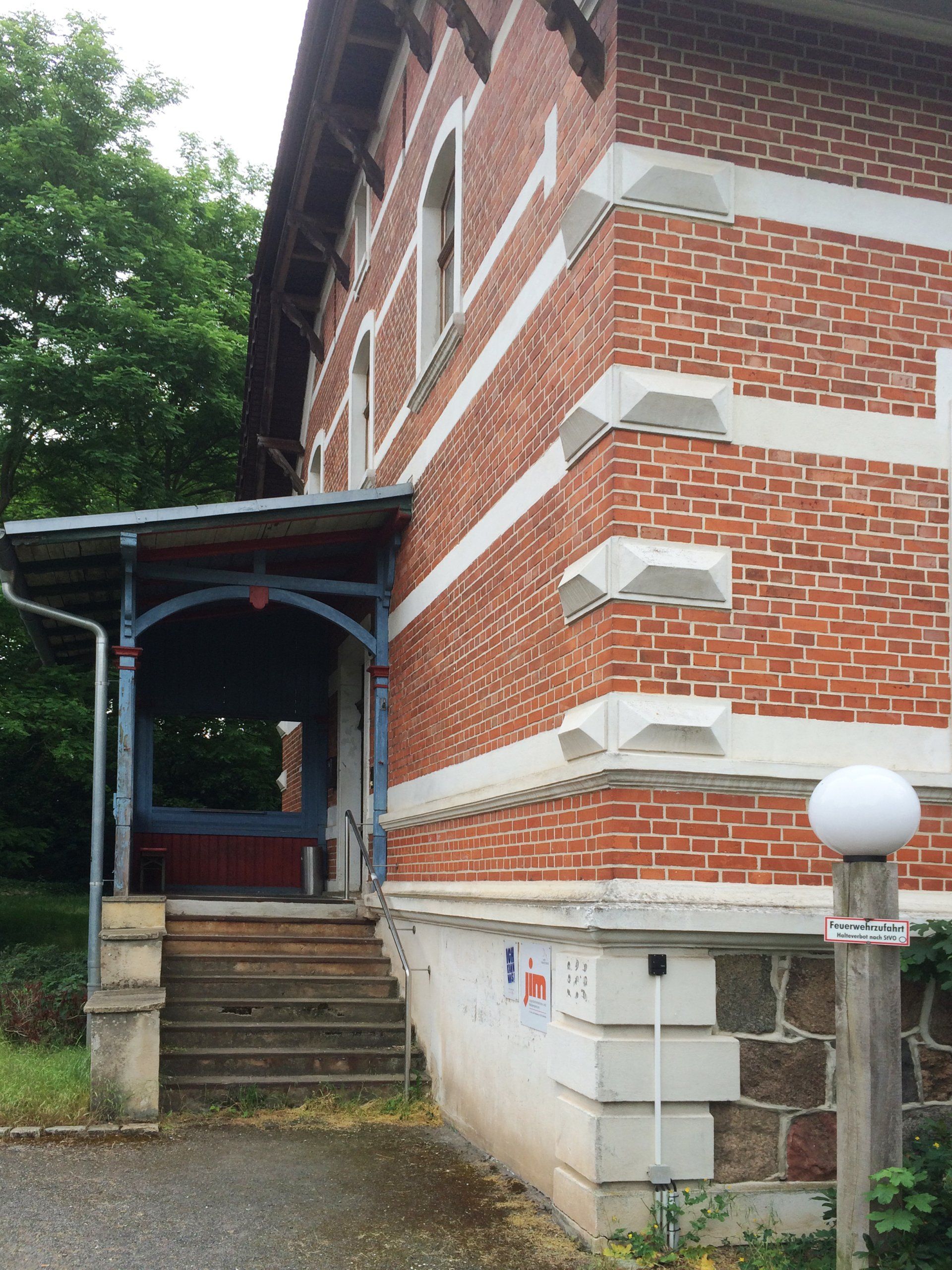 A brick building with stairs leading up to it