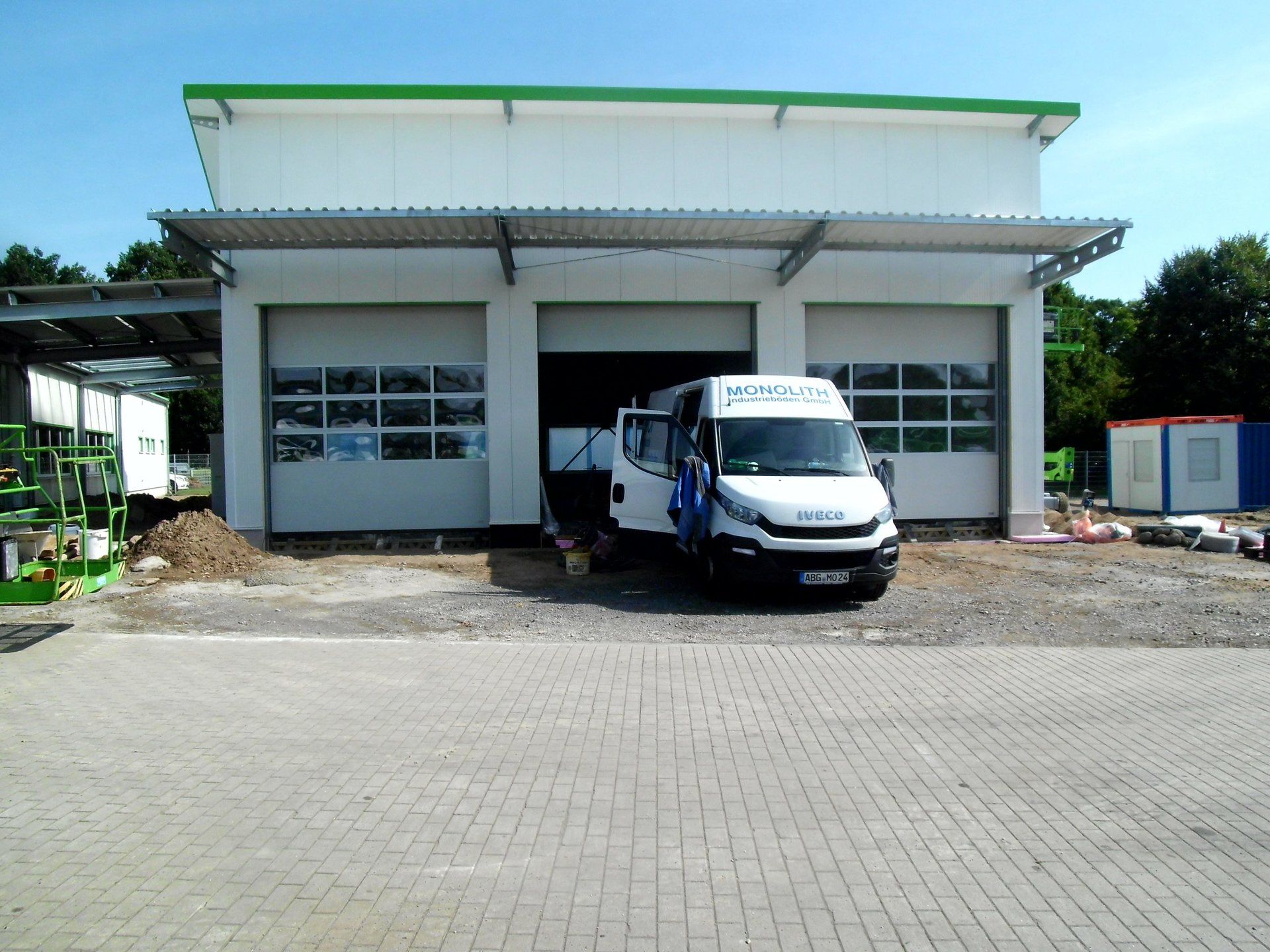 A white van with the word iveco on the side is parked in front of a building