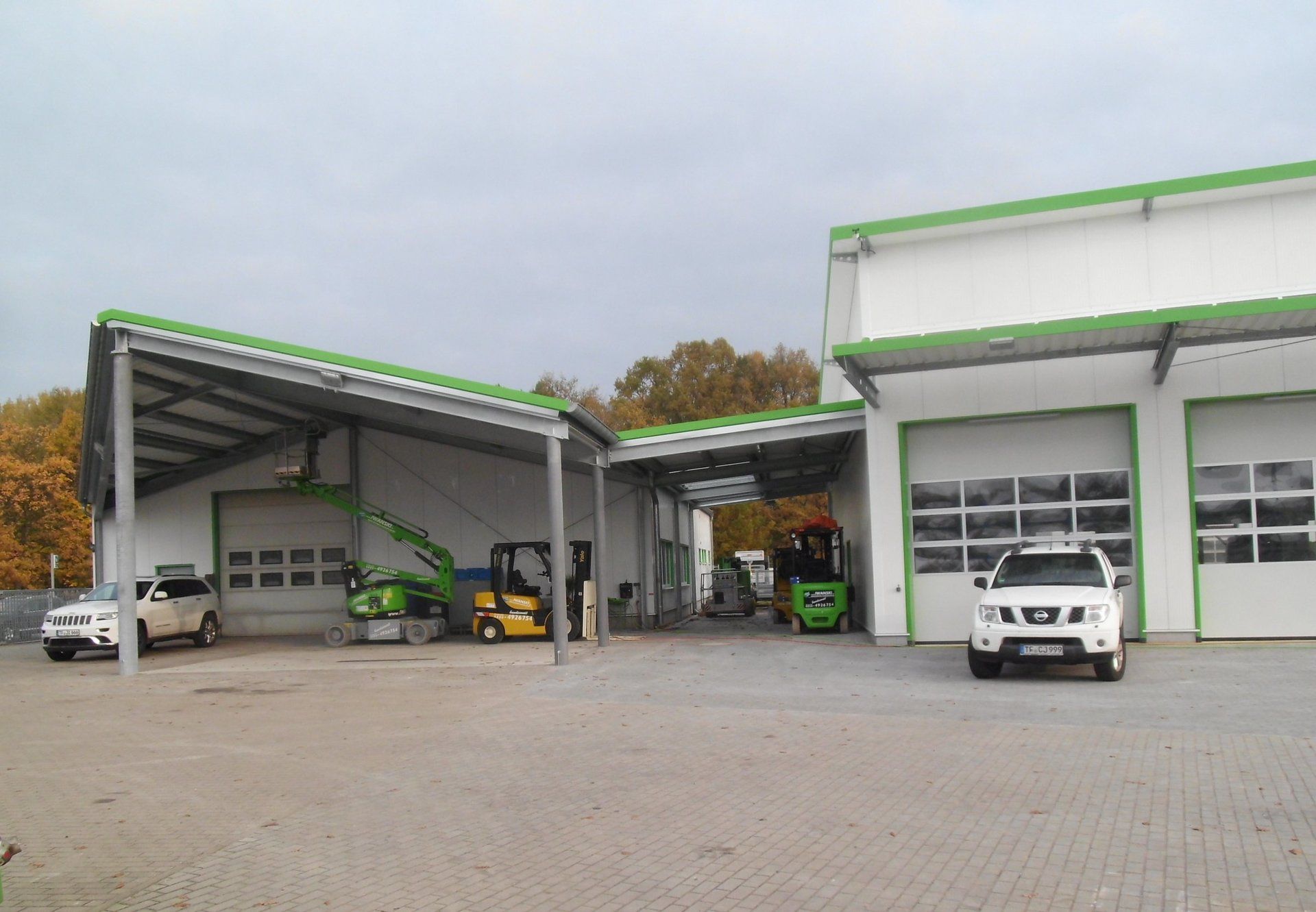 A white truck is parked in front of a building