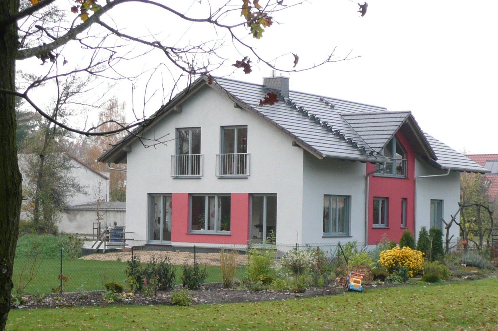 A white and red house with a slate roof