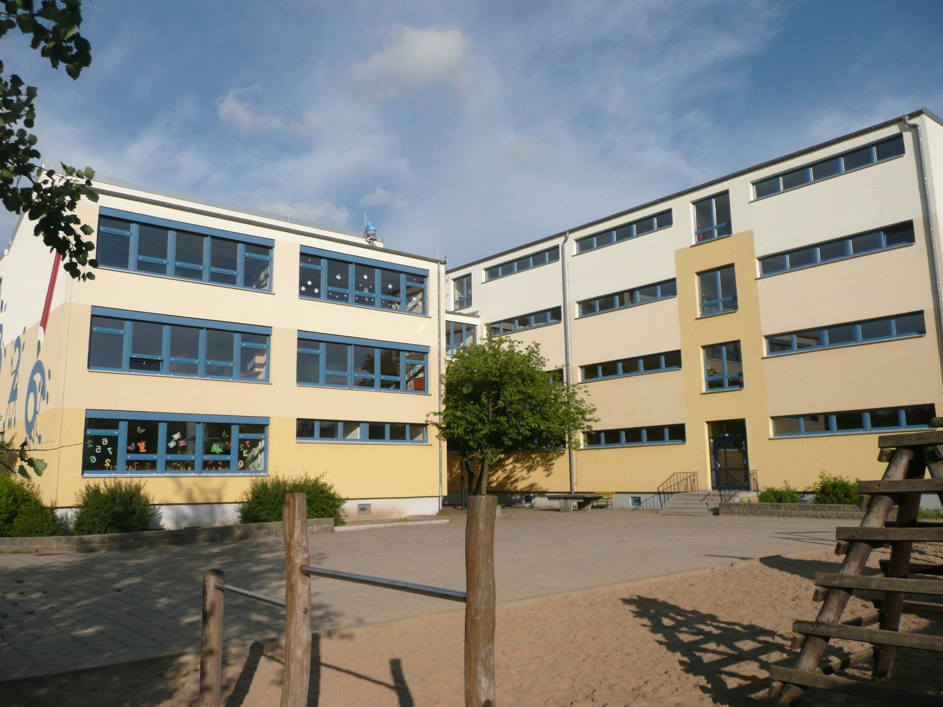 A large building with a playground in front of it