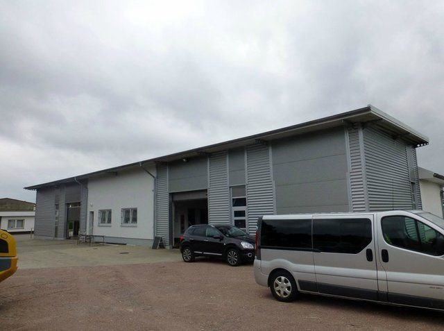 A van is parked in front of a large building