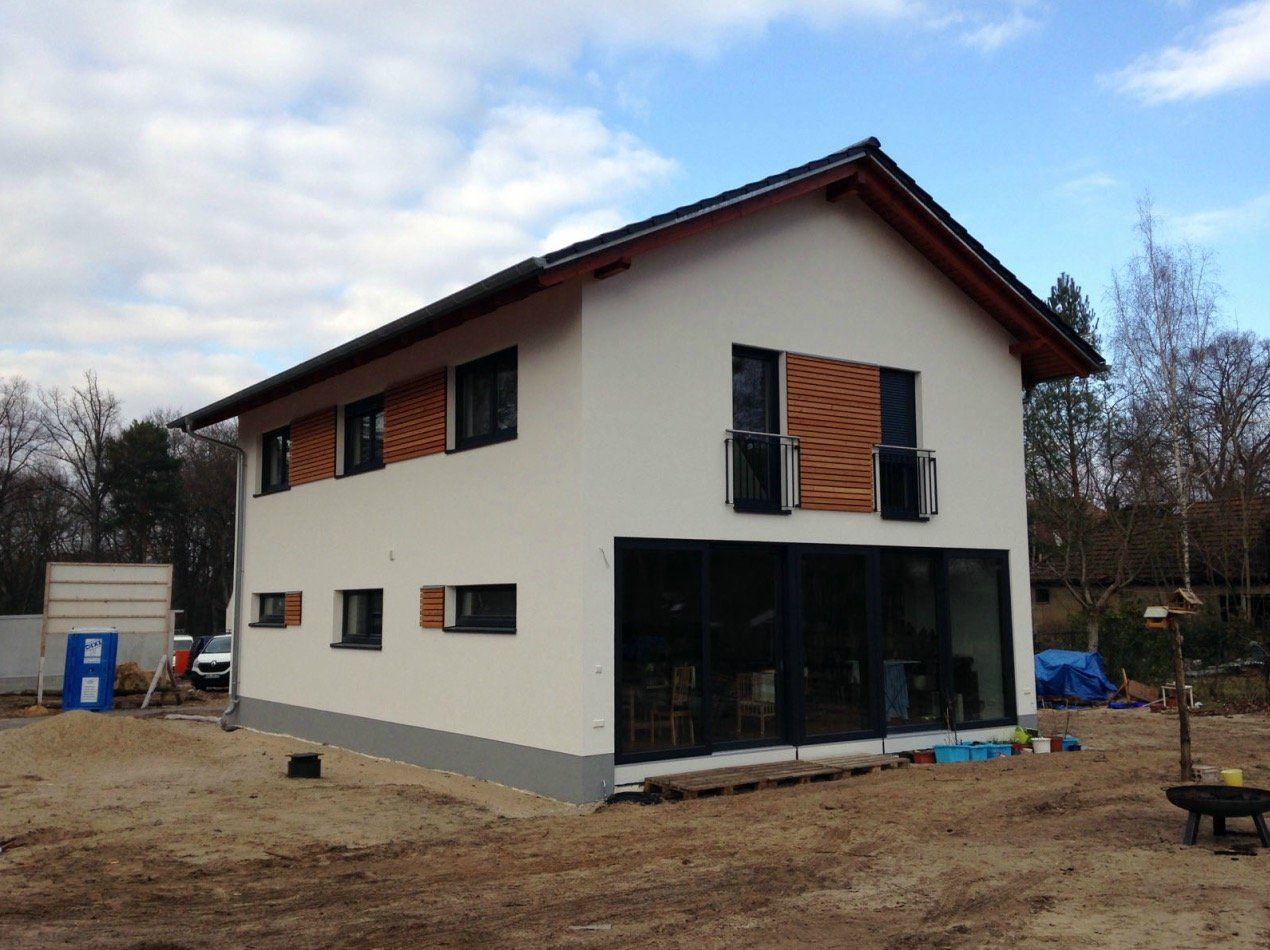 A white house with wooden shutters on the windows