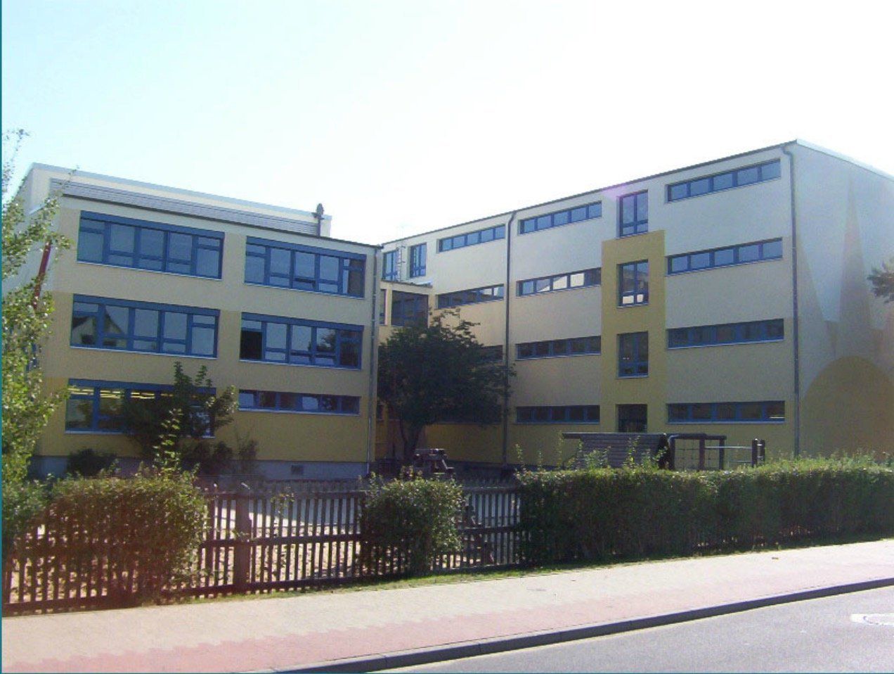 A large yellow building with a lot of windows