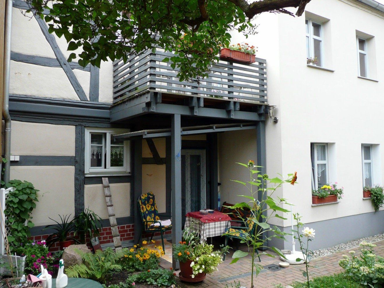A house with a balcony and a table in front of it