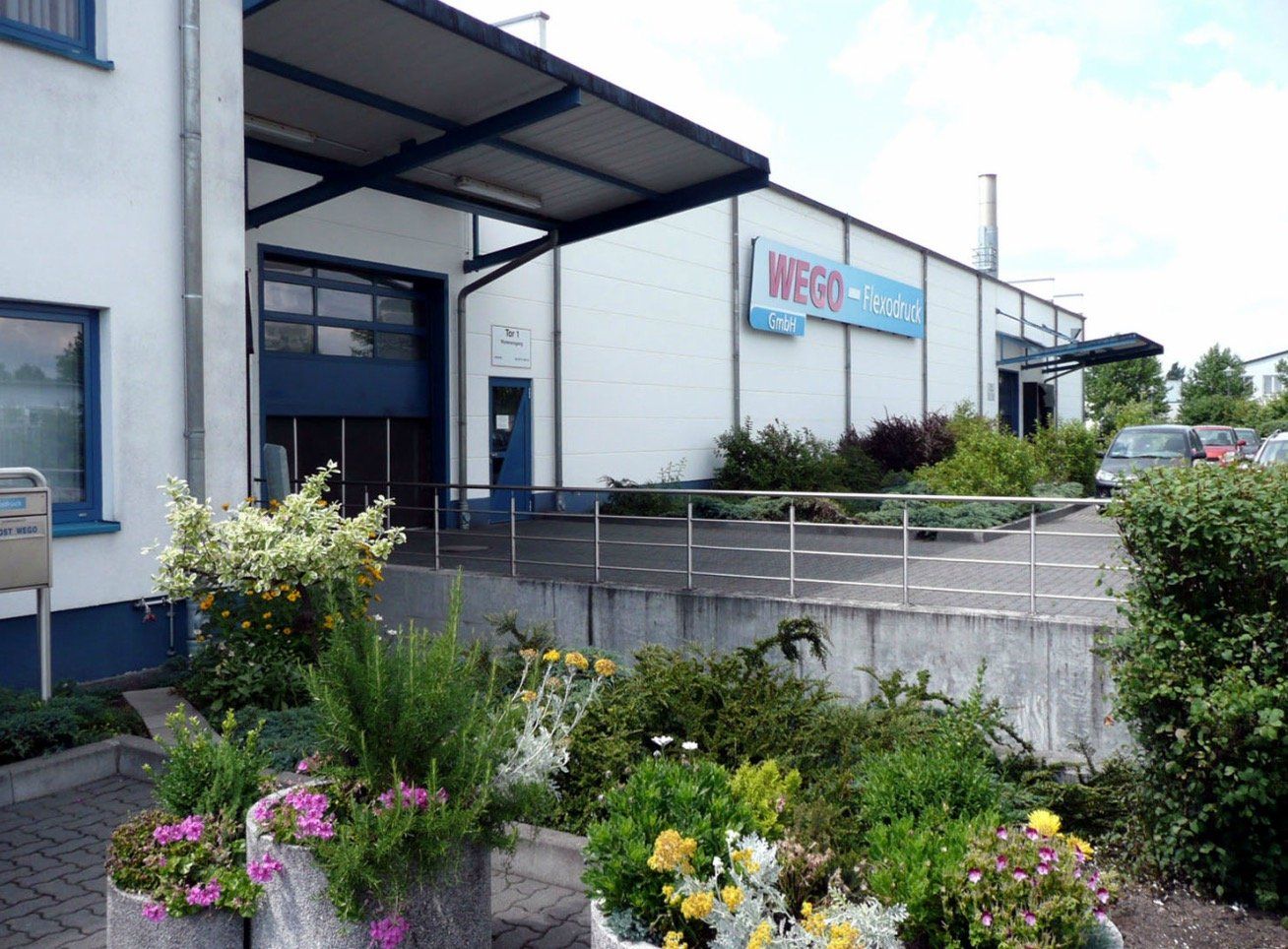 A large white building with flowers in front of it