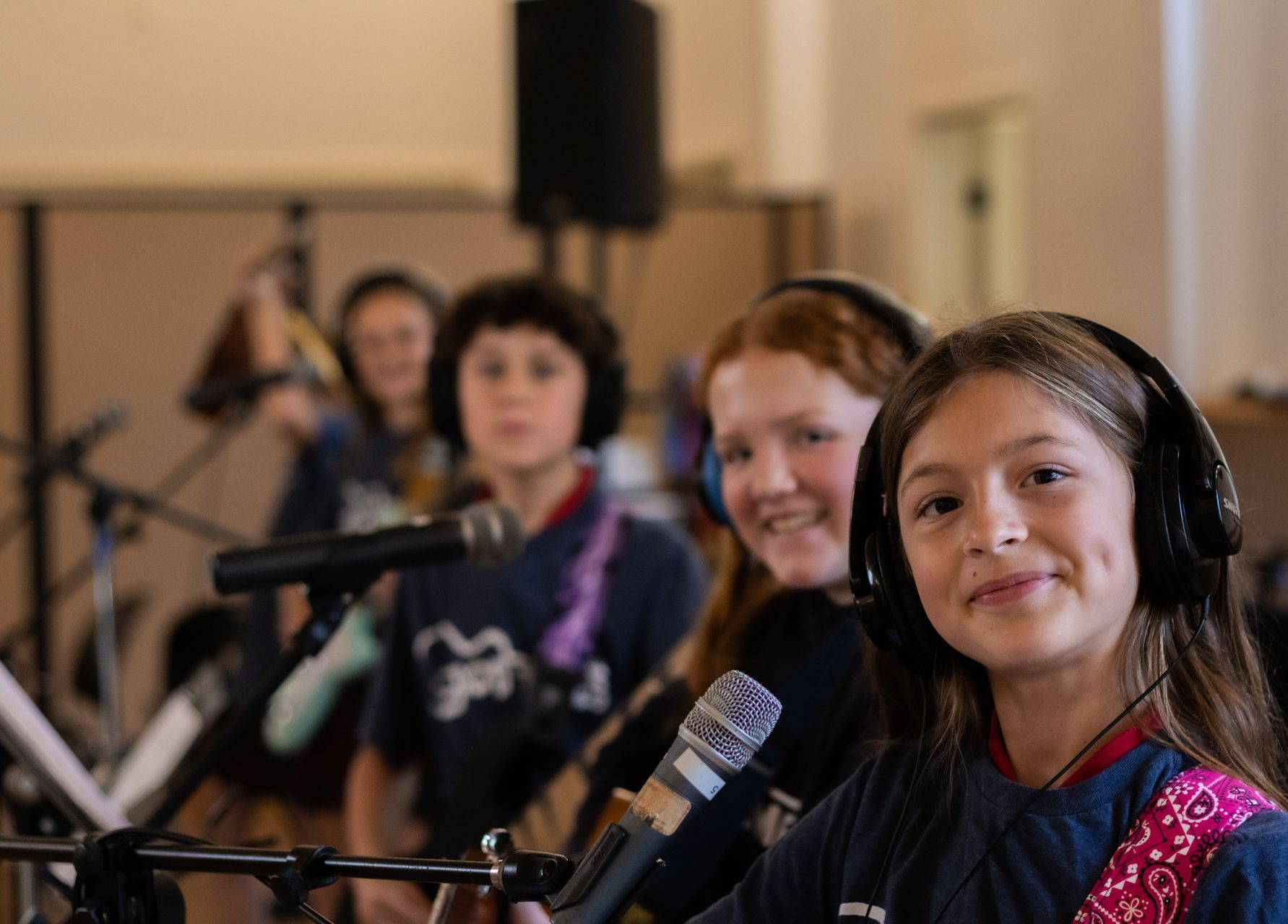 A band practice group smiles while holding their instruments.