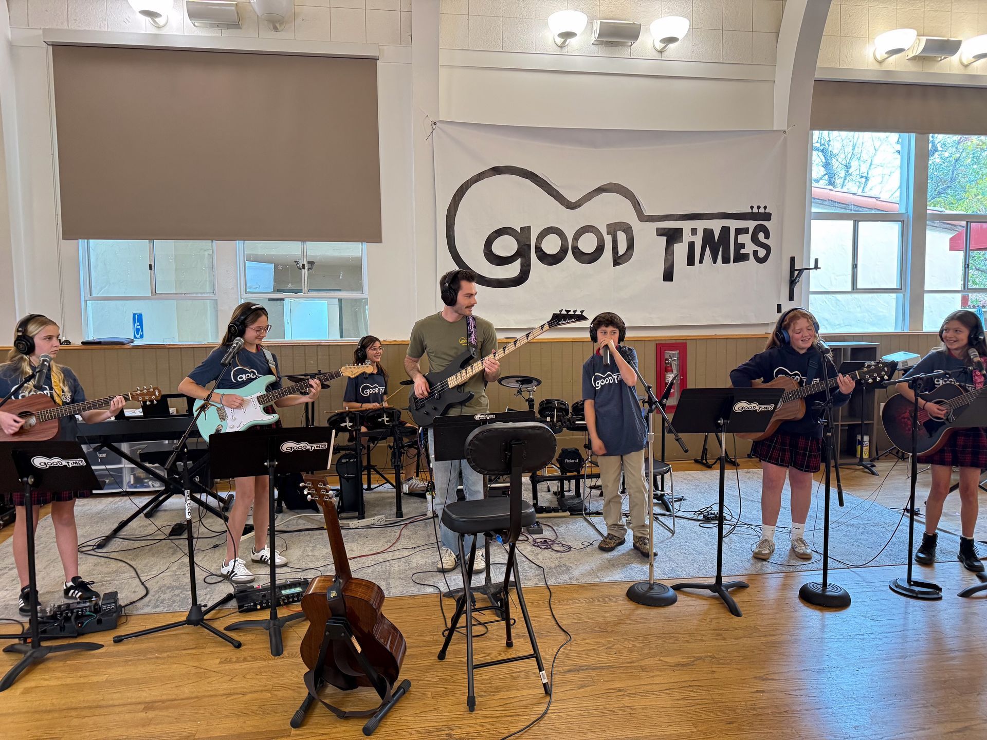 Band performing on a stage with the words 