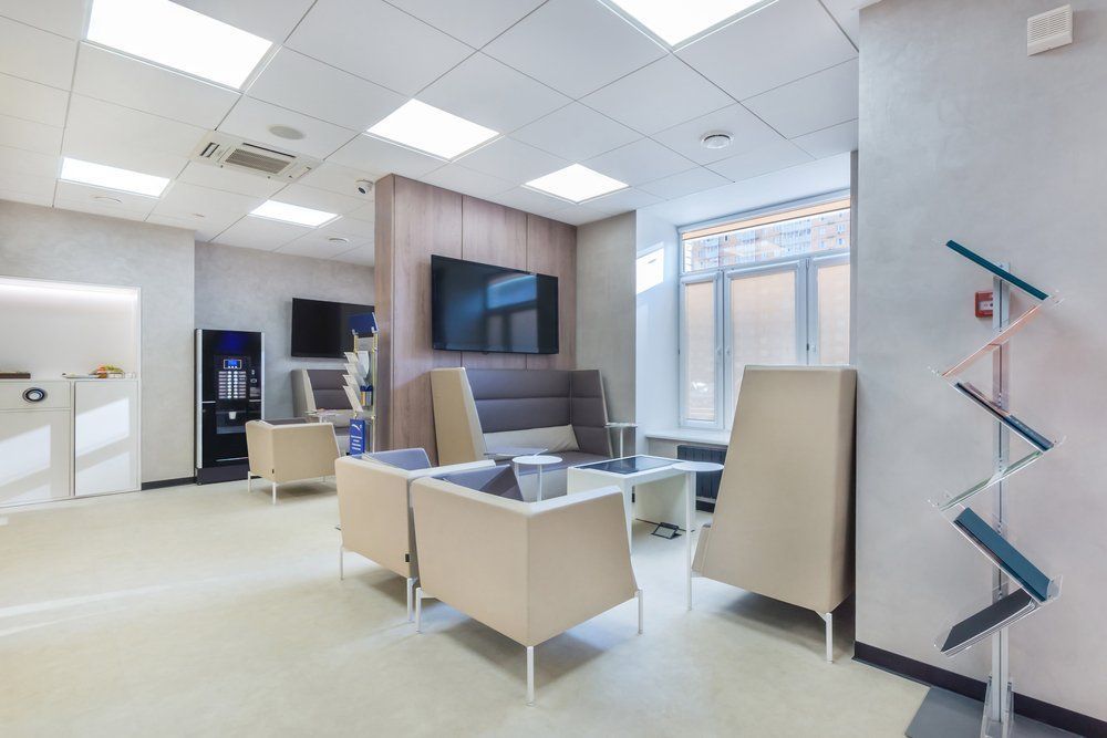 A Waiting Room with Chairs , a Couch and A Television — Renovo Contractors In Monash, ACT