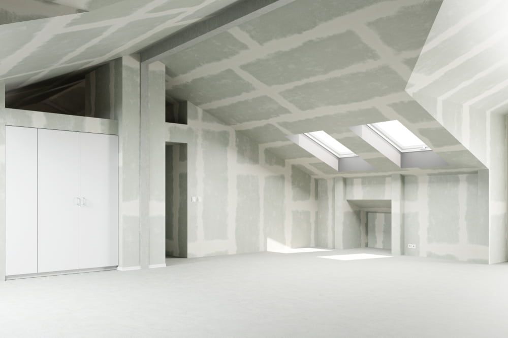 An Empty Room With White Walls And A Skylight In The Ceiling — Renovo Contractors In Monash, ACT