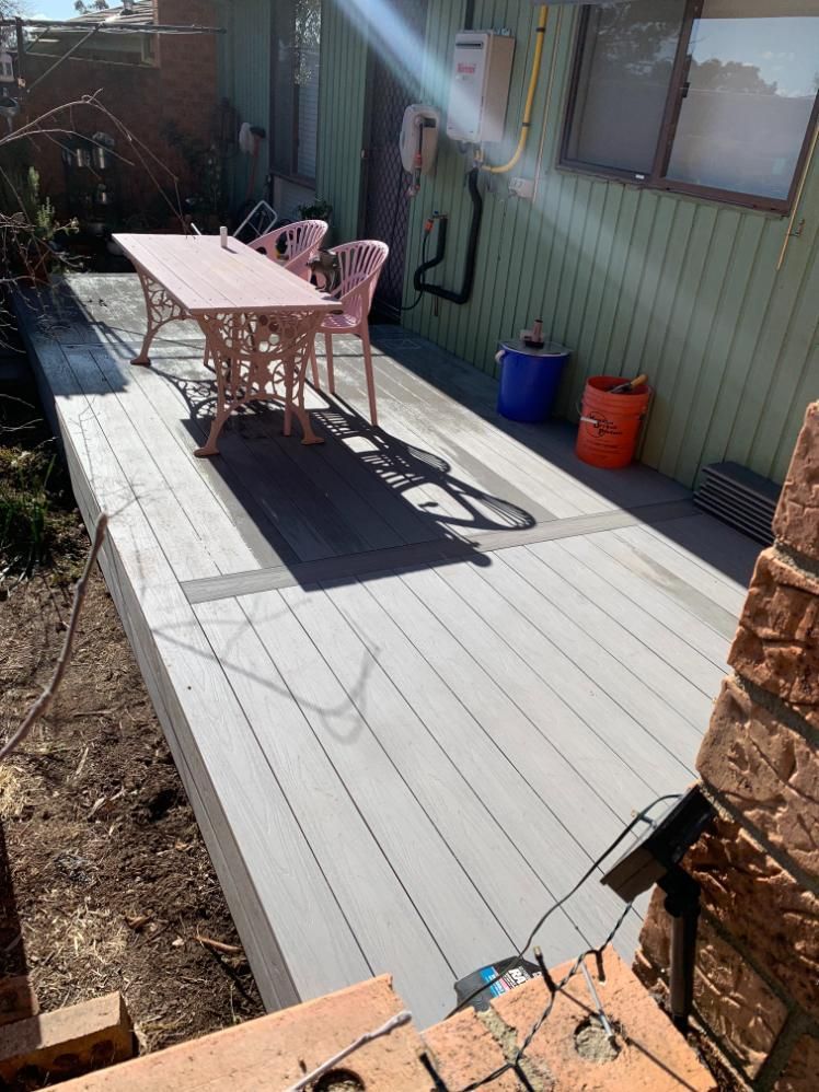 A Deck With A Table And Chairs On It In Front Of A House — Renovo Contractors In Monash, ACT