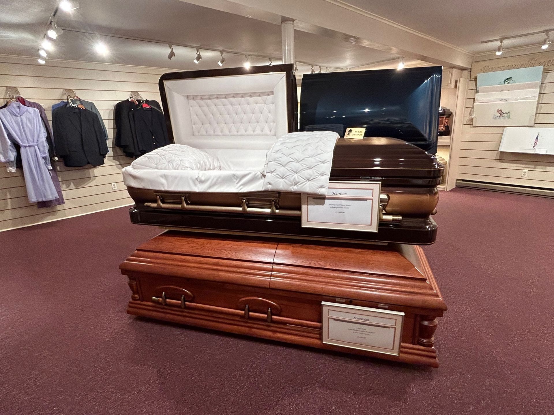 Two coffins on display in a store, one open.