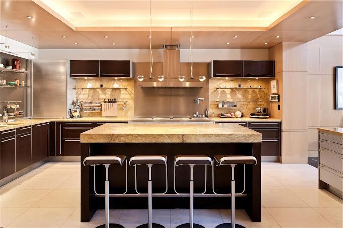 A kitchen with a large island and bar stools