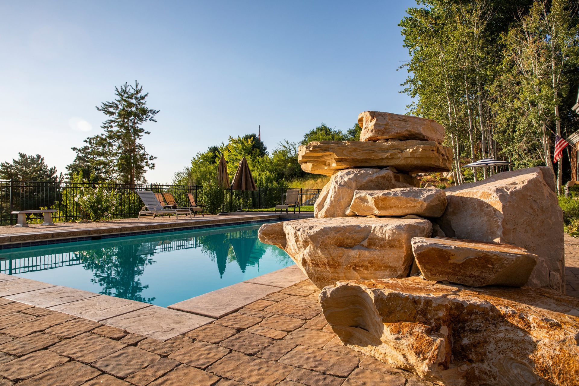A swimming pool with a waterfall in the middle of it