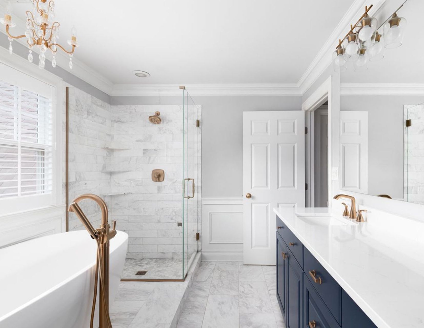 A bathroom with a bathtub , sink , shower and mirror.
