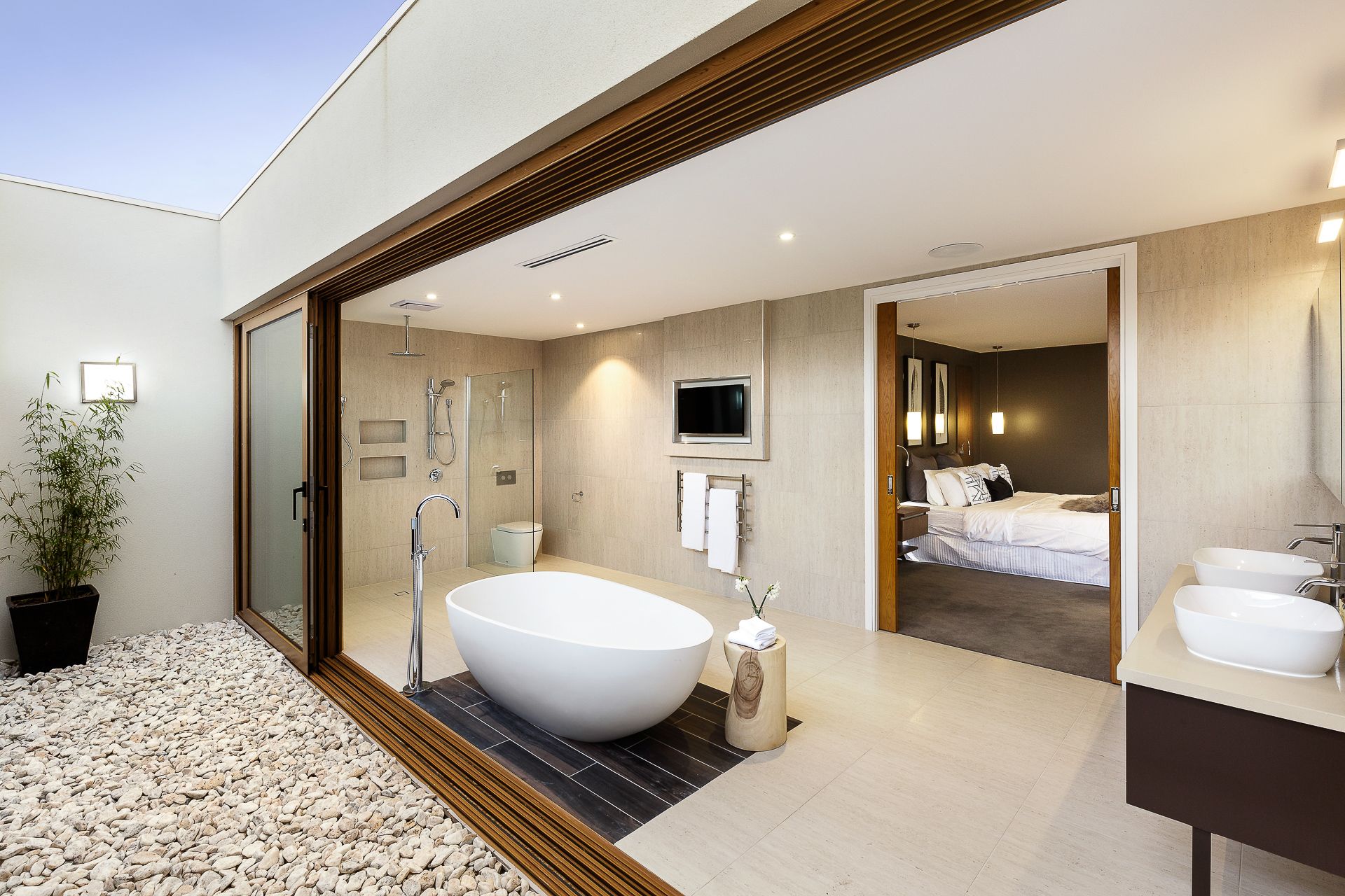 A bathroom with a bathtub and two sinks