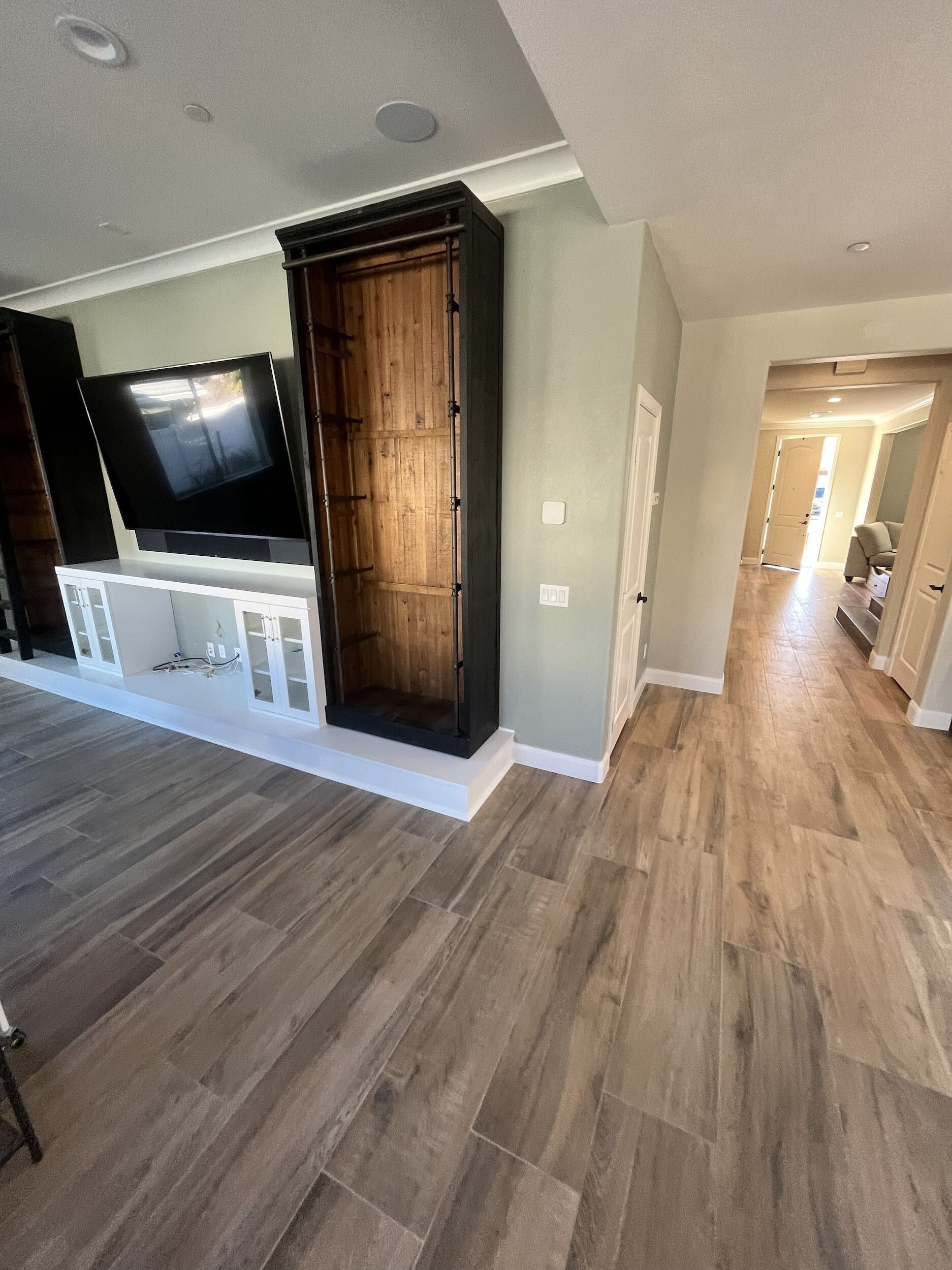 A living room with hardwood floors and a flat screen tv.