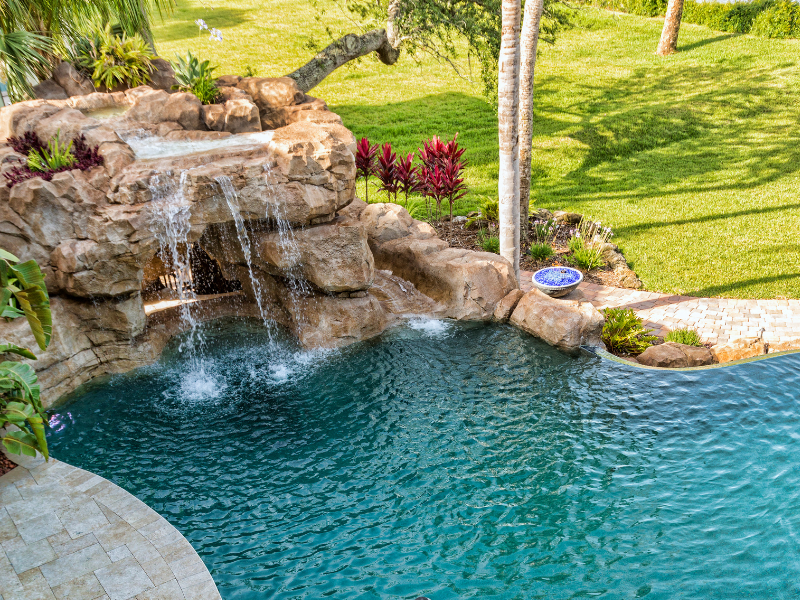 There is a waterfall in the middle of the pool.