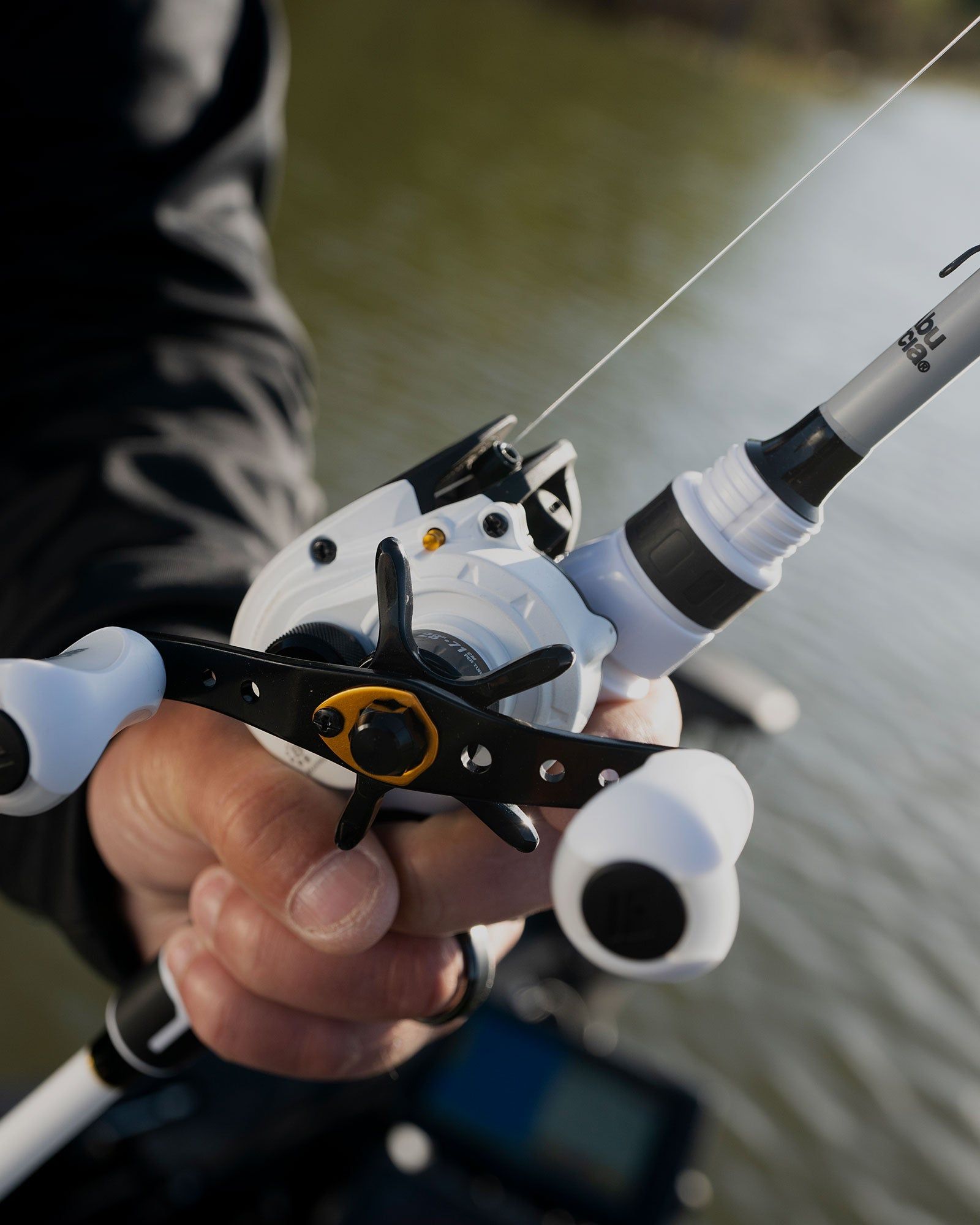A person is holding a fishing rod and reel in their hands