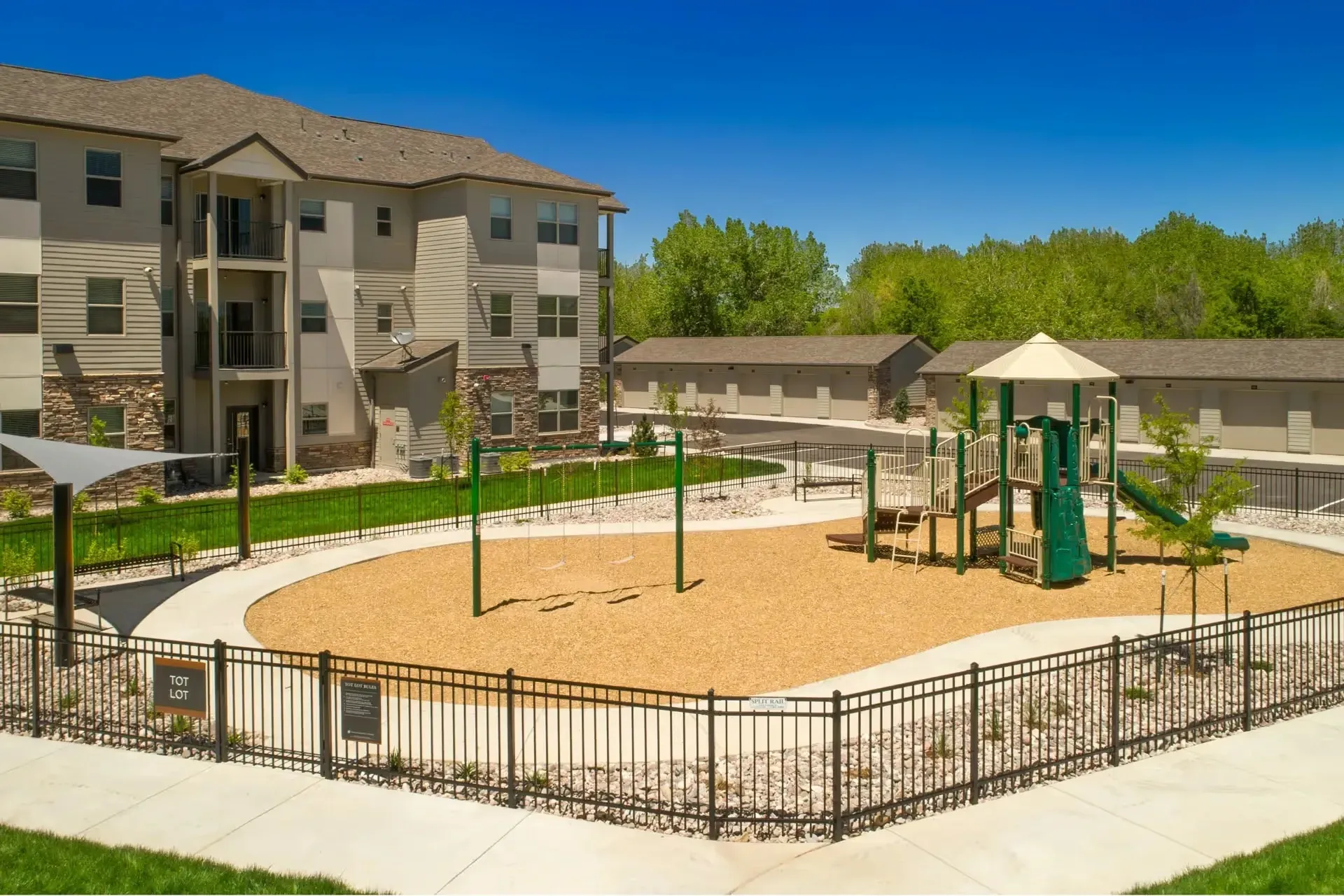Apartment building with a playground and swings.