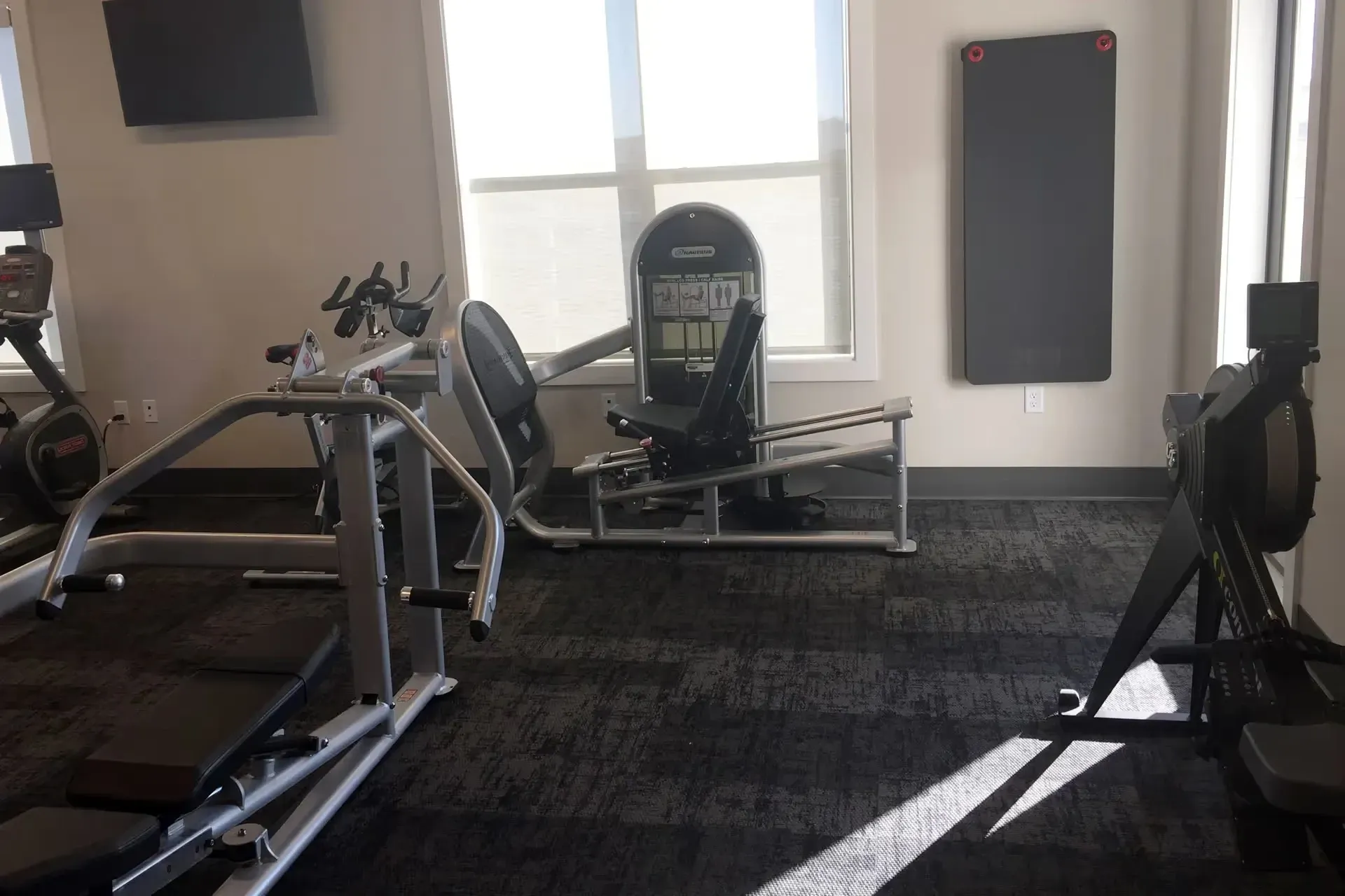 Gym with cardio machines and weight training equipment.